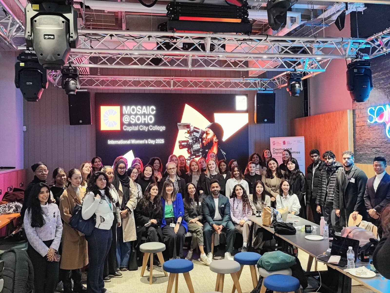 A large group photo at Mosaic at Soho, Capital City College, International Women's Day 2025.