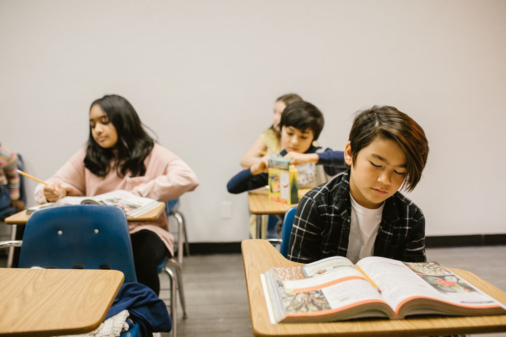 Students reading and studying at their desks.