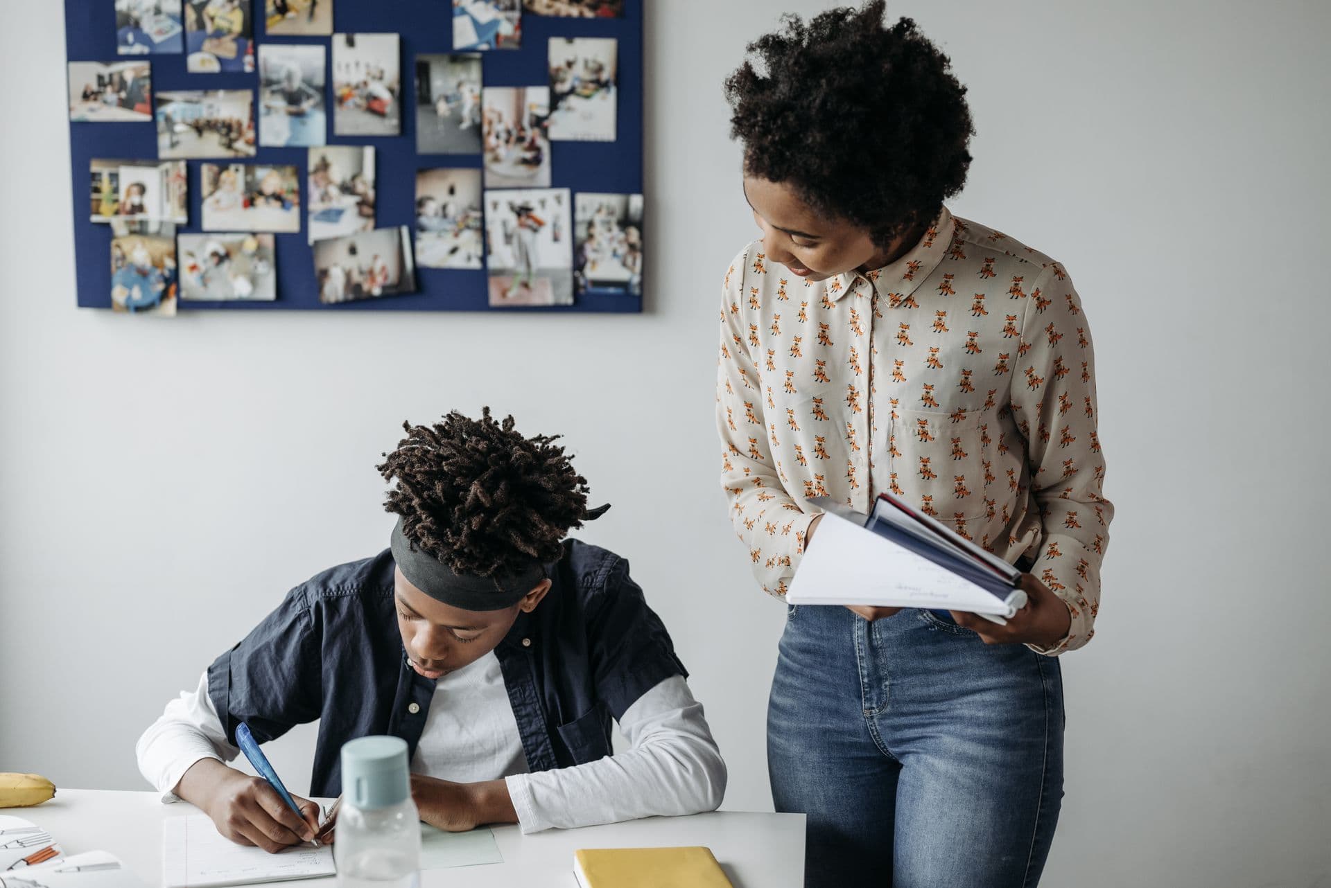 A teacher helping a student with their work in class.